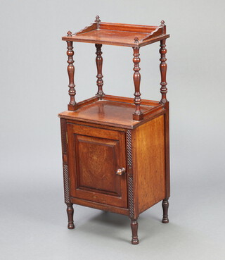 A Victorian mahogany bedside cabinet with raised superstructure to the top, the base enclosed by panelled doors, raised on turned supports 93cm h x 39cm w x 33cm d 
