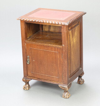 A Chippendale style mahogany bedside cabinet with red inset writing surface above recess, the base enclosed by a panelled door, on cabriole, ball and claw supports 76cm h x 53cm w x 43cm d 