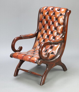 A Regency style mahogany framed open arm chair upholstered in brown buttoned leather, raised on outswept supports 97cm h x 63cm w x 64cm d (seat 30cm x 35cm) 