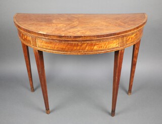 A 19th Century quarter veneered demi-lune card table, raised on square tapered supports ending in spade feet 74cm h x 99cm w x 45cm d 