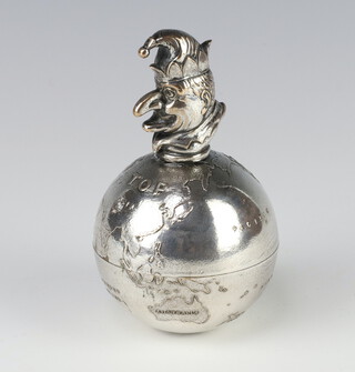 A novelty silver plate paperweight in the form of a globe surmounted by a figure of Mr Punch by J R Gaunt, 12cm 
