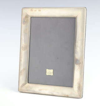 A rectangular silver photograph frame, rubbed marks, 21cm x 15cm, boxed 