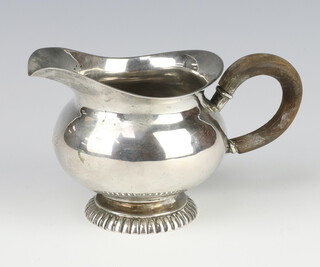 A white metal baluster jug with wood handle, 9cm h