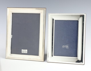 A rectangular silver photograph frame, rubbed marks, 22cm x 17cm, boxed, a silver plated ditto 