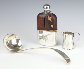An Edwardian silver plated mounted crocodile covered hip flask 18cm (leather distressed), a plated ladle and jug 