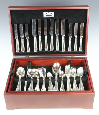 A modern canteen of silver cutlery with beaded decoration for 8, comprising 8 coffee spoons, 8 tea spoons, 8 soup spoons, 8 dessert spoons, 4 table spoons, 8 fish knives, 8 fish forks, 8 dessert forks, 8 dinner forks, Sheffield 1993, 3960 grams together with 8 silver handled dessert knives, 8 silver handled dinner knives, a 3 piece carving set and cheese knife, contained in a mahogany finished box