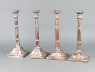 A set of 4 Victorian ex plated column candlesticks decorated with swags and festoons 34cm 