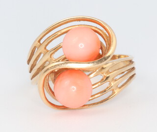 A yellow metal 585 cocktail ring with 2 cabochon coral beads 4.2 grams, size M 1/2