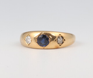 A yellow metal gypsy set sapphire and diamond ring, the sapphire 0.3ct, the 2 diamonds each 0.10ct, 4.9 grams, size Q 