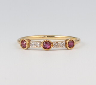 An 18ct yellow gold ruby and diamond ring, the 3 rubies 0.05ct each, the 4 diamonds 0.02ct each, 1.6 grams, size P 1/2 