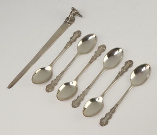 Six silver coffee spoons Birmingham 1977 together with a silver paperknife with hound handle, 64 grams 