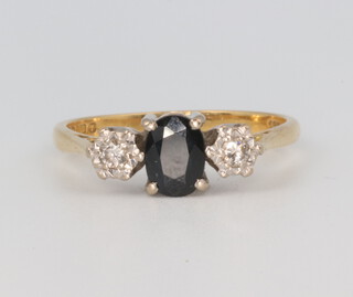 An 18ct yellow gold sapphire and diamond 3 stone ring, the centre stone 0.70ct, the outer 2 stones 0.06ct, size P, 3.5 grams 