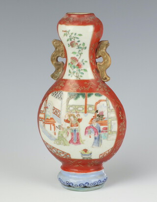 A 19th Century Qing Dynasty famille rose wall vase of bottle shape with gilt dragon handles, with a panel of a lady on a fenced veranda with attendants, the neck decorated with peony 18cm 