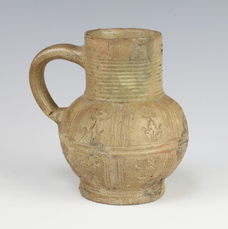 A 17th/18th Century stoneware jug with incised floral decoration 12cm 