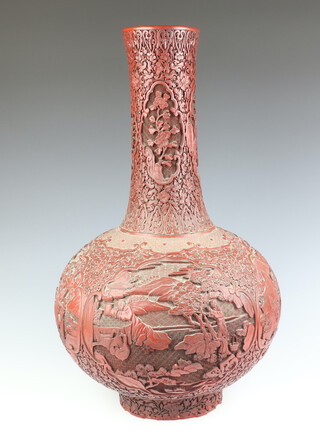 An impressive 19th Century Qing Dynasty cinnabar lacquered bottle vase, decorated with panels of scholars and children in gardens in a rocky river landscape, with panels of lotus, prunus, peony and chrysanthemums 60cm h  

