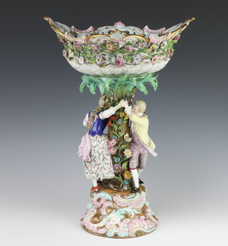 A good 19th Century Meissen porcelain centrepiece with pierced floral encrusted and painted pierced basket, the tree trunk support floral encrusted with flowers with 2 dancing figures raised on a Rococo base 49cm 
