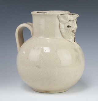 A Victorian crackle glazed Earthenware jug with mythical mask spout and simple handle 26cm 