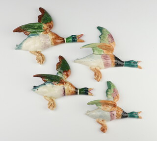 A Beswick wall plaque in the form of a flying duck 5963 19cm, 3 others unmarked 16cm, 15cm and 13cm 