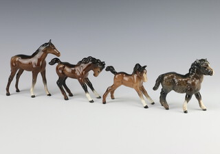 A Beswick figure of Shetland foal no.1034, brown gloss 9.5cm, a foal large thoroughbred, brown gloss 11.9cm, a foal no 1085, brown gloss 8.9cm, ditto foal small stretched facing right, chestnut gloss 8.3cm, all modelled by Arthur Greddington 
