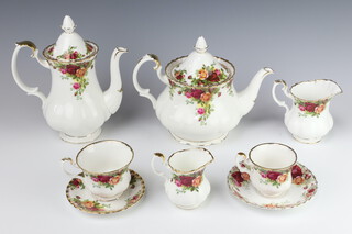 A Royal Albert Old Country Rose part tea and coffee service comprising 6 small tea cups, 7 large tea cups, 6 small saucers, 8 large saucers, a teapot, coffee pot, milk jug, cream jug, 2 sugar bowls, 6 small plates, sandwich plate, side plate and a dinner plate 