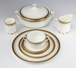 A Royal Albert/Paragon Athena pattern tea and dinner service comprising 8 coffee cups, 8 saucers, 8 two handled bowls, 8 small plates, 8 side plates, 8 dinner plates, 2 tureens and covers, a meat plate, sandwich plate, 2 vegetable bowls, 5 dessert bowls, cream jug, sauce boat (all seconds) 