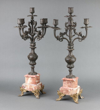 A pair of 19th Century Continental spelter 5 light candelabrum raised on pink veined marble bases 61cm h x 14cm w x 14cm d 