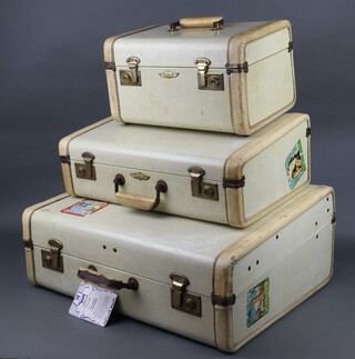 Flite 69, a suite of 1950's luggage comprising vanity case with gilt mounts and luggage label marked Toronto Canada National Exhibition 19cm h x 34cm w x 22cm d, a suitcase the interior labelled People's Watch Company and with Canada label to the side 14cm h x 46cm w x 32cm d (some light corrosion and rubbing to the handle), a fitted suitcase with 3 Canadian luggage labels Mount Royal overlooking Montreal, Ivy Lea Bridge Thousand Islands Otter and Daytona Beach (torn), 47cm h x 53cm w x 23cm d (slight tears and contact marks in places)   