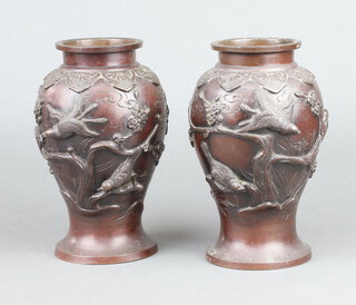 A pair of Japanese 19th Century bronze vases decorated birds, on circular bases, 20cm h x 9cm diam. 