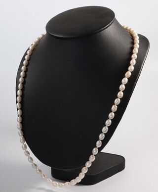A baroque cultured pearl necklace with garnet terminals 64cm, having a 9ct yellow gold clasp 