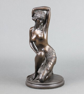 A bronzed figure of an Egyptian style kneeling lady, raised on a circular base 35cm h x 16cm diam. 