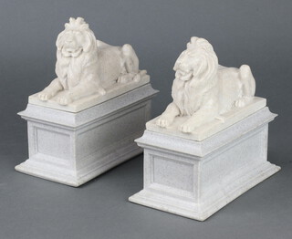 A pair of resin bookends in the form of recumbent lions on rectangular bases 19cm h x 19cm x 10cm  