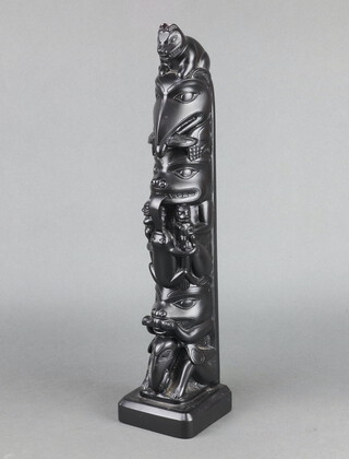 Boma, a resin model of a totem pole 49cm h x 11cm w x 10cm d 