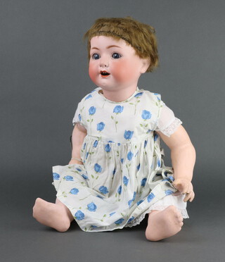 An early 20th Century Heubach Koppelsdorf bisque headed doll stamped 321.8 Germany, having open and closing eyes and articulated limbs 