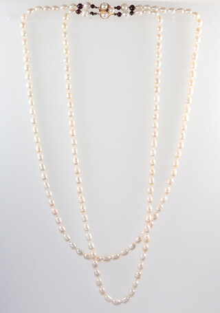 A baroque cultured pearl double strand necklace with a 14ct yellow gold pearl and sapphire set clasp 66cm 