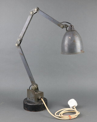 A Grey Memlite steel articulated industrial lamp attached to a circular steel base