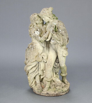 A well weathered concrete garden figure of a couple, raised on a circular base 76cm h x 31cm diam. 