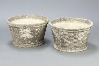 A pair of well weathered circular concrete garden planters with basket work decoration, 26cm h x 45cm diam.  