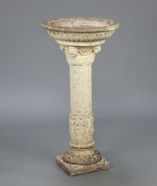 A circular well weathered concrete garden bird bath, raised on a Corinthian style column 61cm h x 42cm diam. 