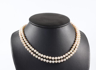A strand of cultured pearls with gilt metal clasp 85cm 