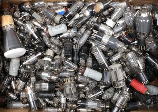 A collection of loose valves including Rathone, Mallard, Mazda and others, contained in a green fruit box  