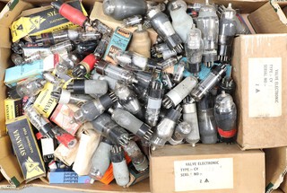 A collection of valves including Mallard, Sylvania and others contained in a green fruit box 