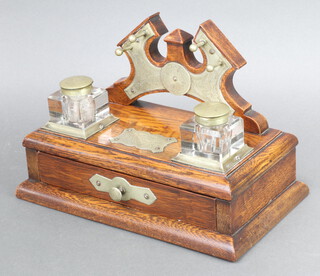 An Edwardian oak, glass and silver plated ink stand with pen rest and 2 cut glass inkwells, the drawer fitted a base with plaque marked Kinnoull REC Club, Presidents Surprise 1911 18cm h x 28cm w x 16cm d 