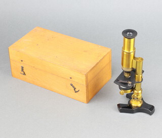A student's 19th Century gilt metal binocular microscope, cased  