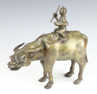 A Qing Dynasty 19th Century Chinese bronze figure of a boy on a buffalo in four square with its head turning quizitivly to the left, the boy holding a stick in his raised right hand and double gourd in hist  24cm x 28cm x 9cm 