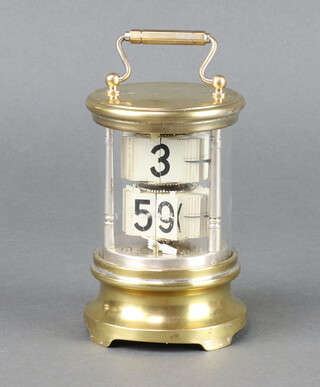 Eveready, a 1930's desk top flip ticket clock contained in a cylindrical gilt metal and glass case 12cm x 8cm diam. 