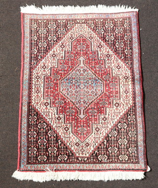 A Persian pink and grey ground rug with central diamond medallion 99cm x 72cm 