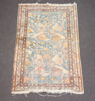 A Caucasian style blue and tan ground floral patterned rug 144cm x 97cm 