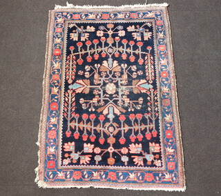 A blue, red and green ground floral patterned Persian rug 154cm x 107cm 
