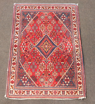A red, blue and white ground Belouche rug with diamond shaped medallion to the centre within a multi row border 163cm x 114cm 