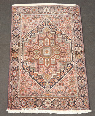 A pink, blue and white ground Iranian rug with diamond shaped central medallion 154cm x 100cm 